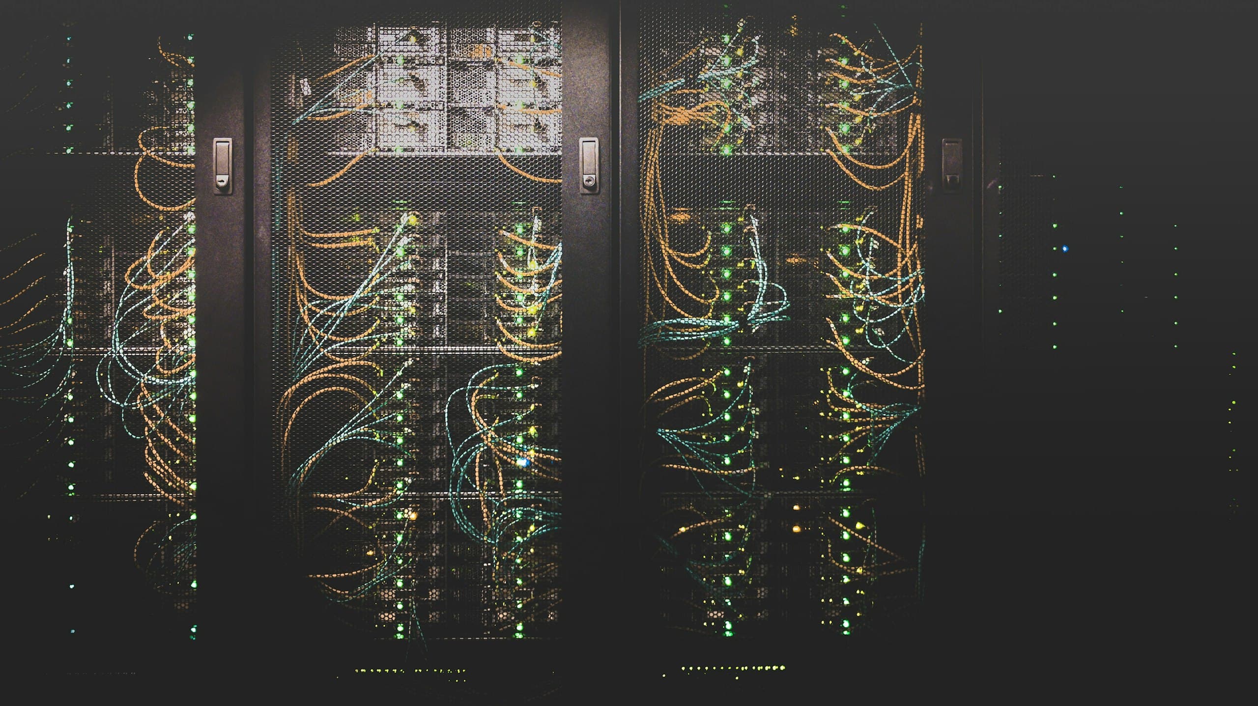 Fibre and copper runs dressed into a row of datacenter racks